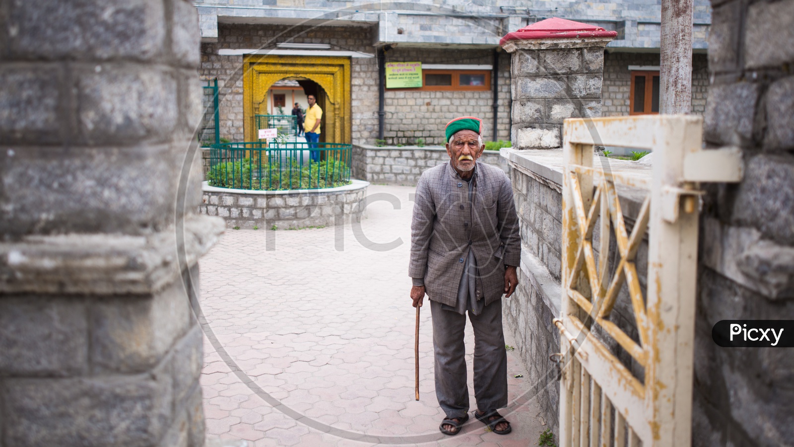 An Old Man In His Traditional Attire At a Temple In Spiti Valley
