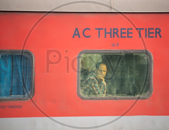 A Passenger Looking Through the Window Glass from  a AC Three tier  Bogie of Indian railways Train