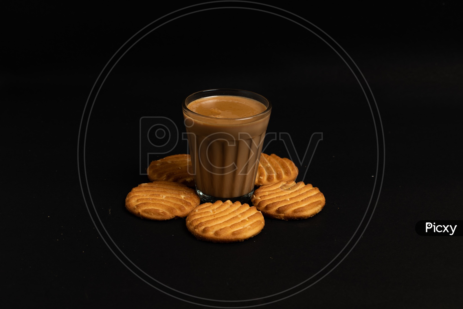 Aromatic beverage Tea/chai   with Good-day biscuits placed  on a black background.