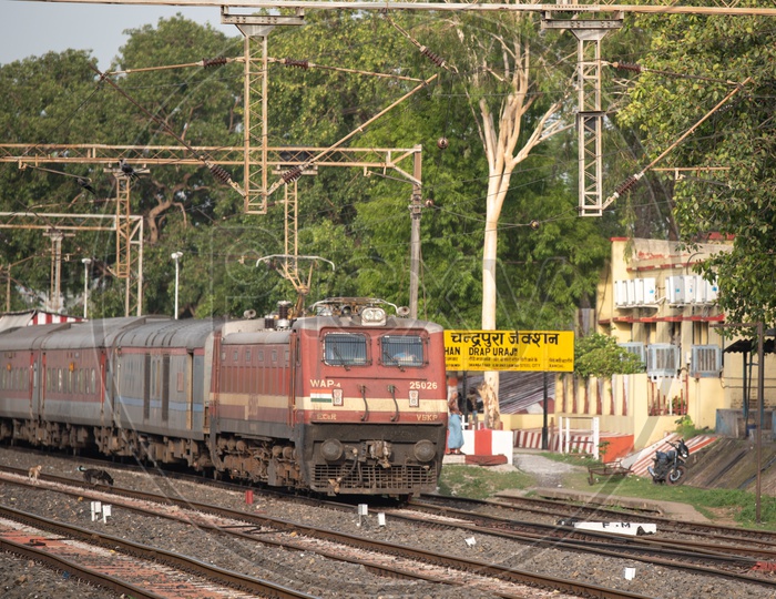 Indian Railways Train On a Platform With a View Of Adjacent  Tracks And Electricity Poles