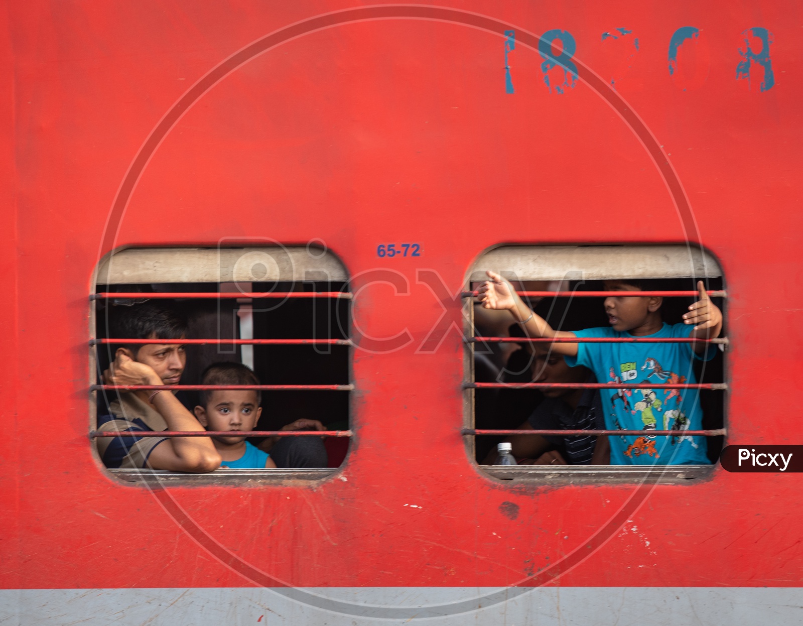 Indian Children Sitting At a train Window Seat And Looking Through The Window  In an Indan Railway Train Coach Or Bogie