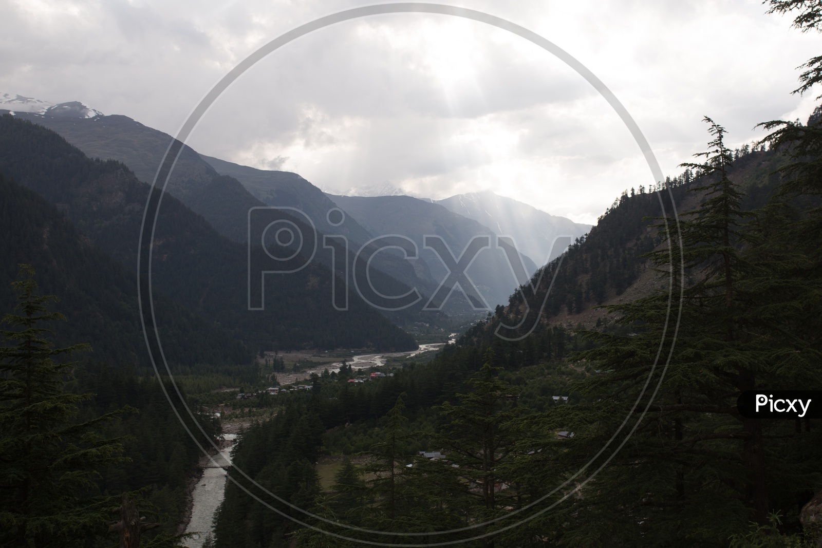 Landscape Views With Snow Capped Mountains And Cotton  fog Clouds And Green Terrain Hills on the River Valleys