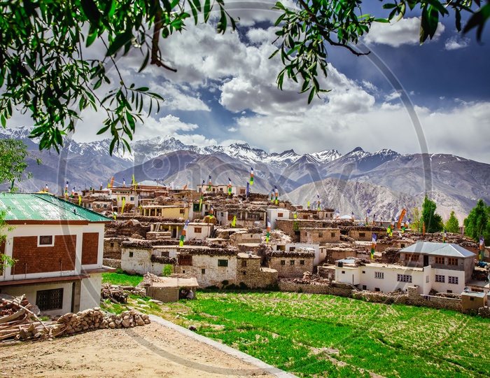 A View Of Snow Capped Mountains From The Villages Of Spiti Valley With Houses In the Village