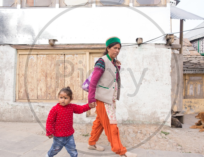 A Mother Walking With Her Child In  The Village Streets Of  Spiti