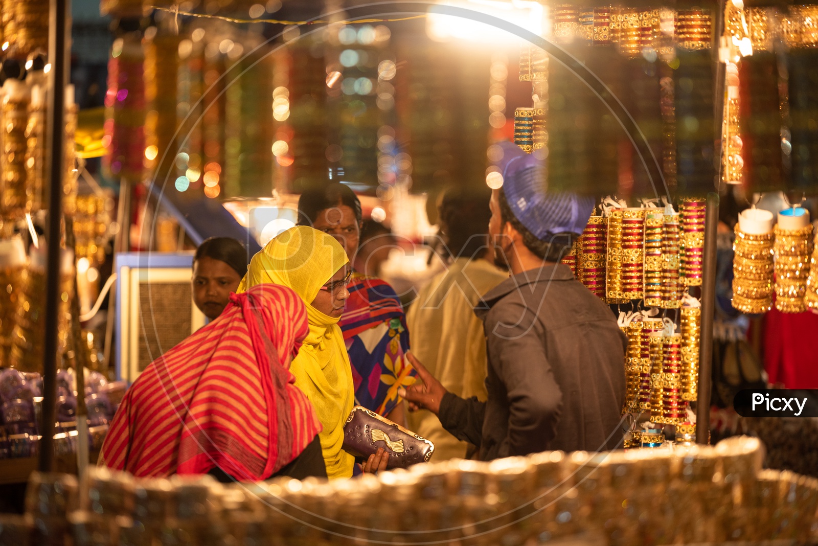 A Young Muslim Woman In Bhurkha   Shopping  Bangles  in a  Vendor Stall Around Charminar  During  Ramadan or Ramzan Season