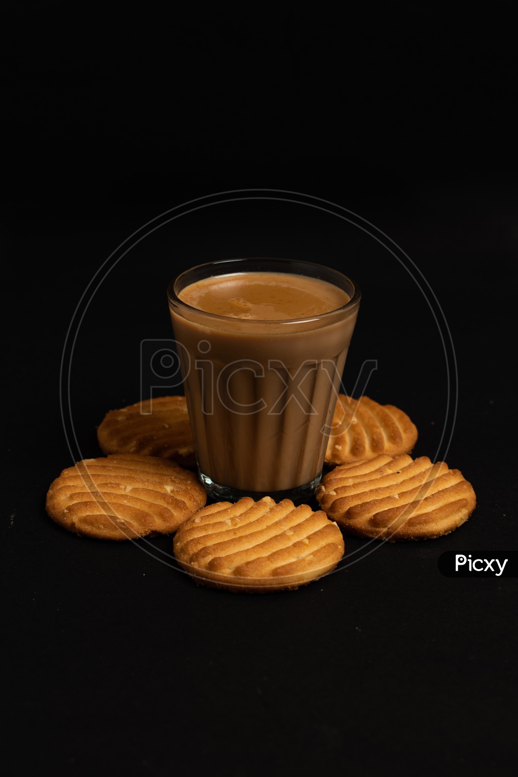 Aromatic beverage Tea/chai   with Good-day biscuits placed  on a black background.