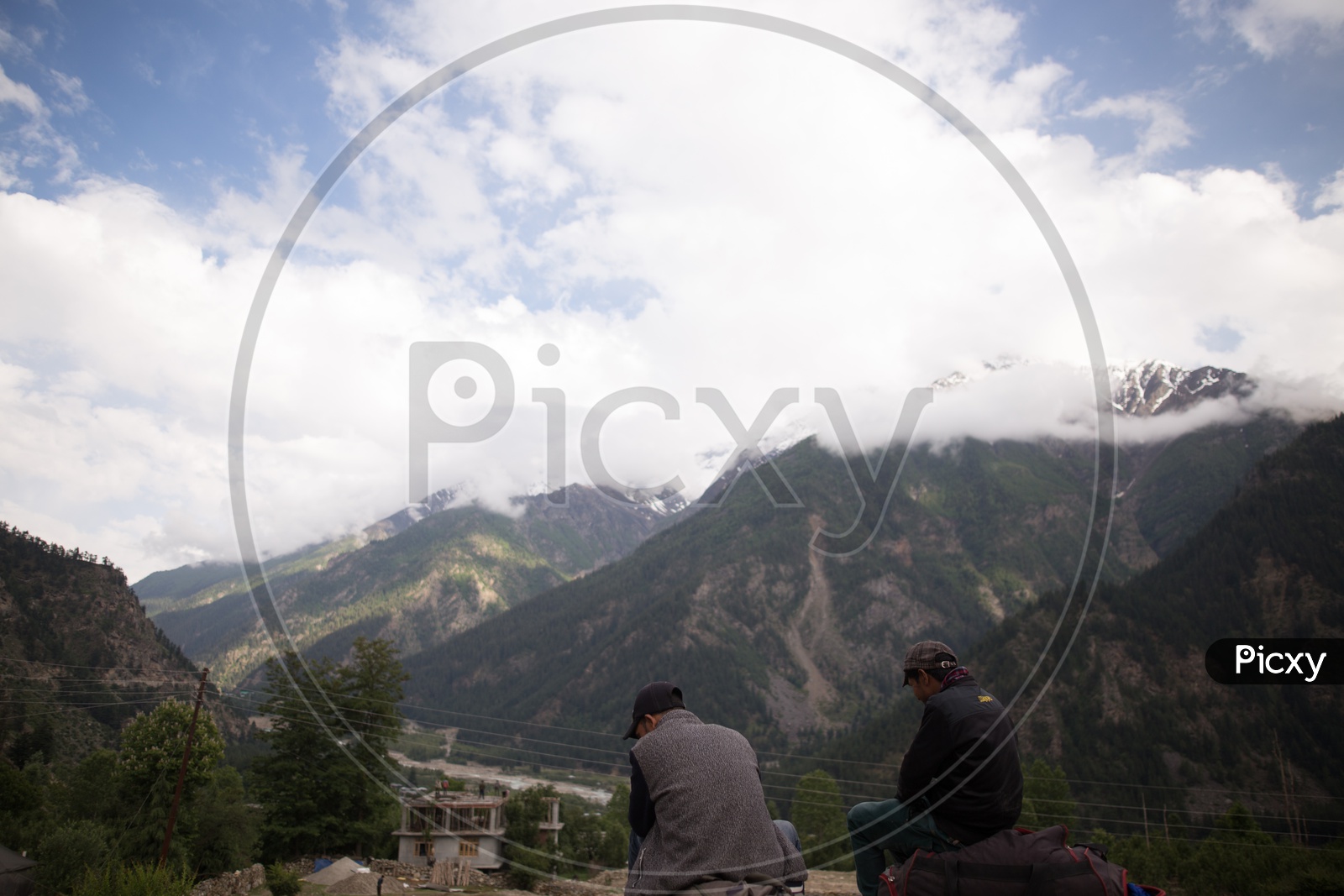 Tourists Or Local People Enjoying The Valley Views With Snow Capped Mountains And Hills