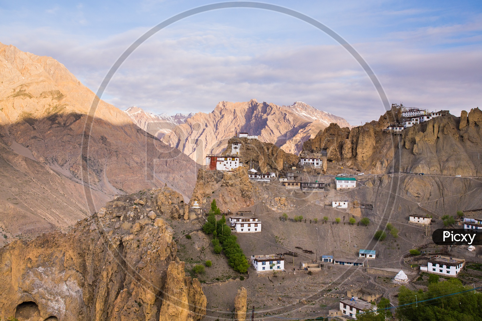 Houses On The Terrains Of Spiti Valley With Snow Capped Mountains In Background