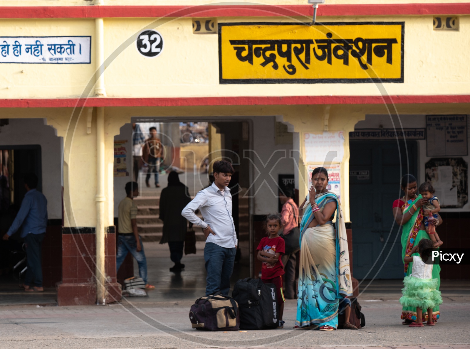 Passengers Or Family Waiting In a Railway Station Platform