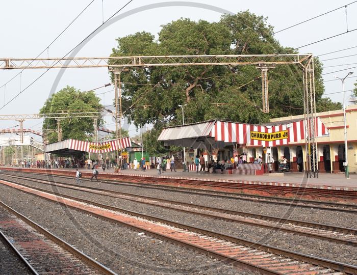 A Railway Station With Passengers Waiting For The Train  With a View of Track And Electric Poles  In a Indian Railways  Railway Station