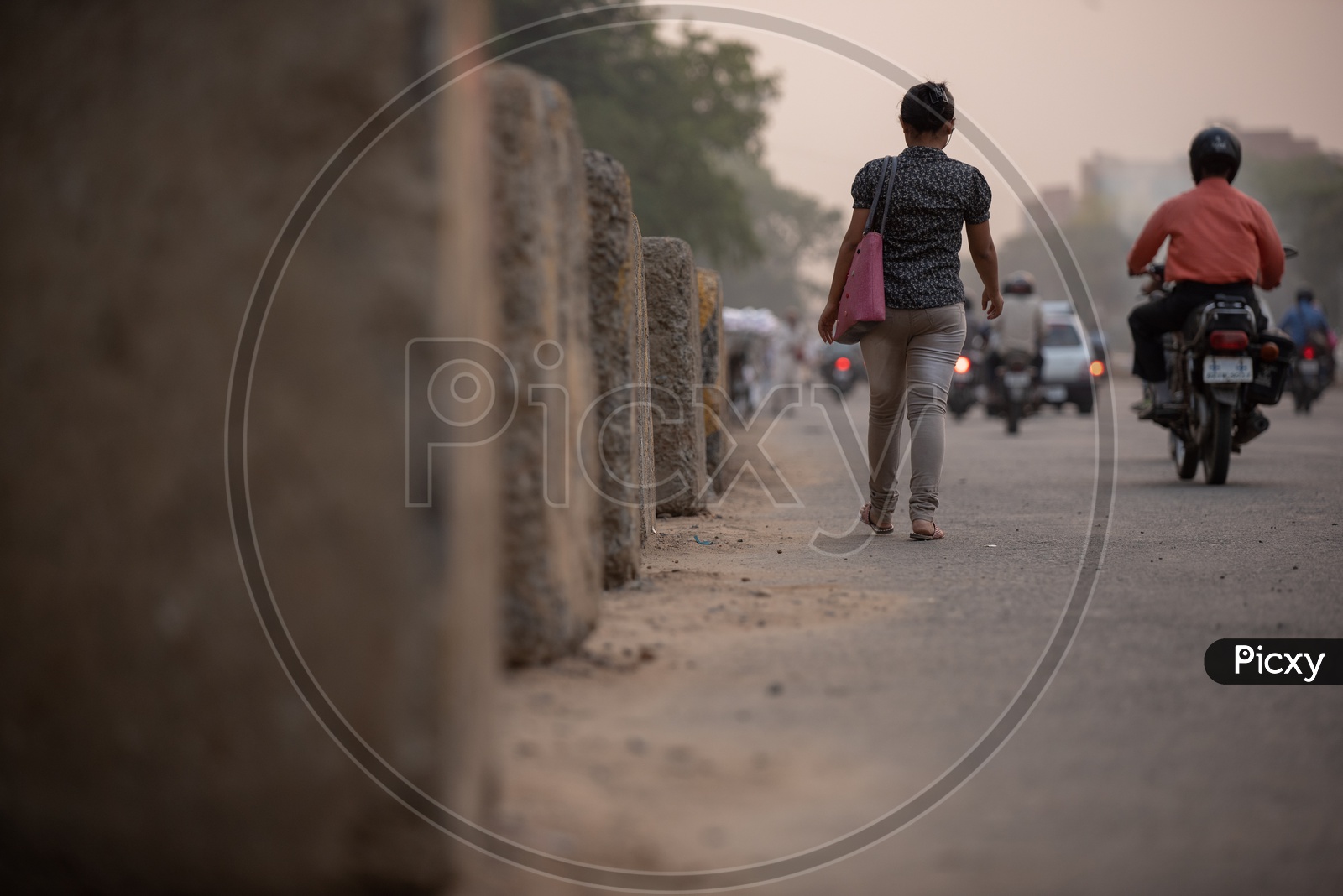A Young Indian Woman Walking On  A Road