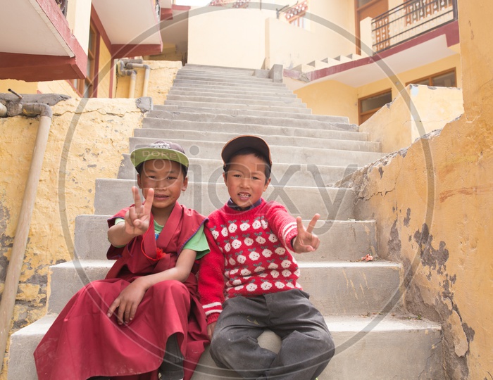 Buddhist Monk Children In red Dress Attire at The Buddhist Monasteries In The Valleys Of Spiti