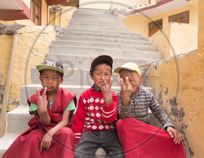Buddhist Monk Children In red Dress Attire at The Buddhist Monasteries In The Valleys Of Spiti