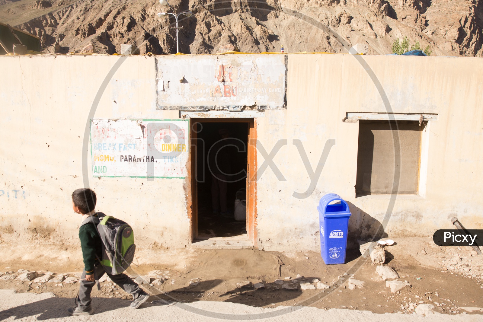 A School Boy Carrying His  School Bag In His  Back at Tabo Village