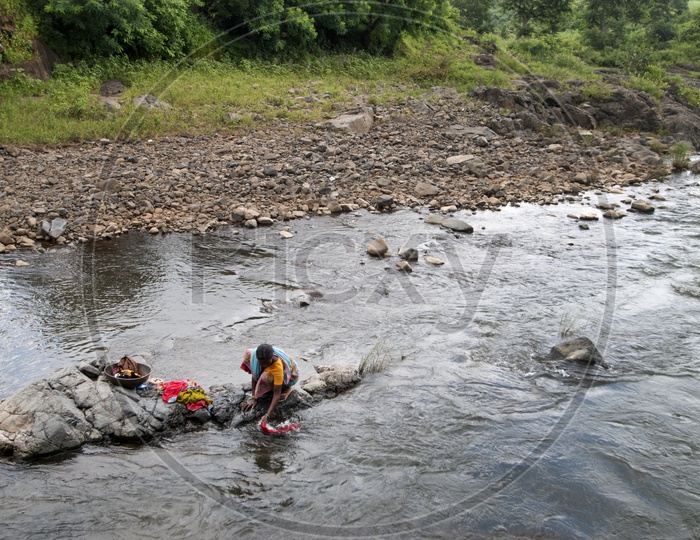 A Tribal Woman Washing Clothes In The Water Channels In The Tribal Villages