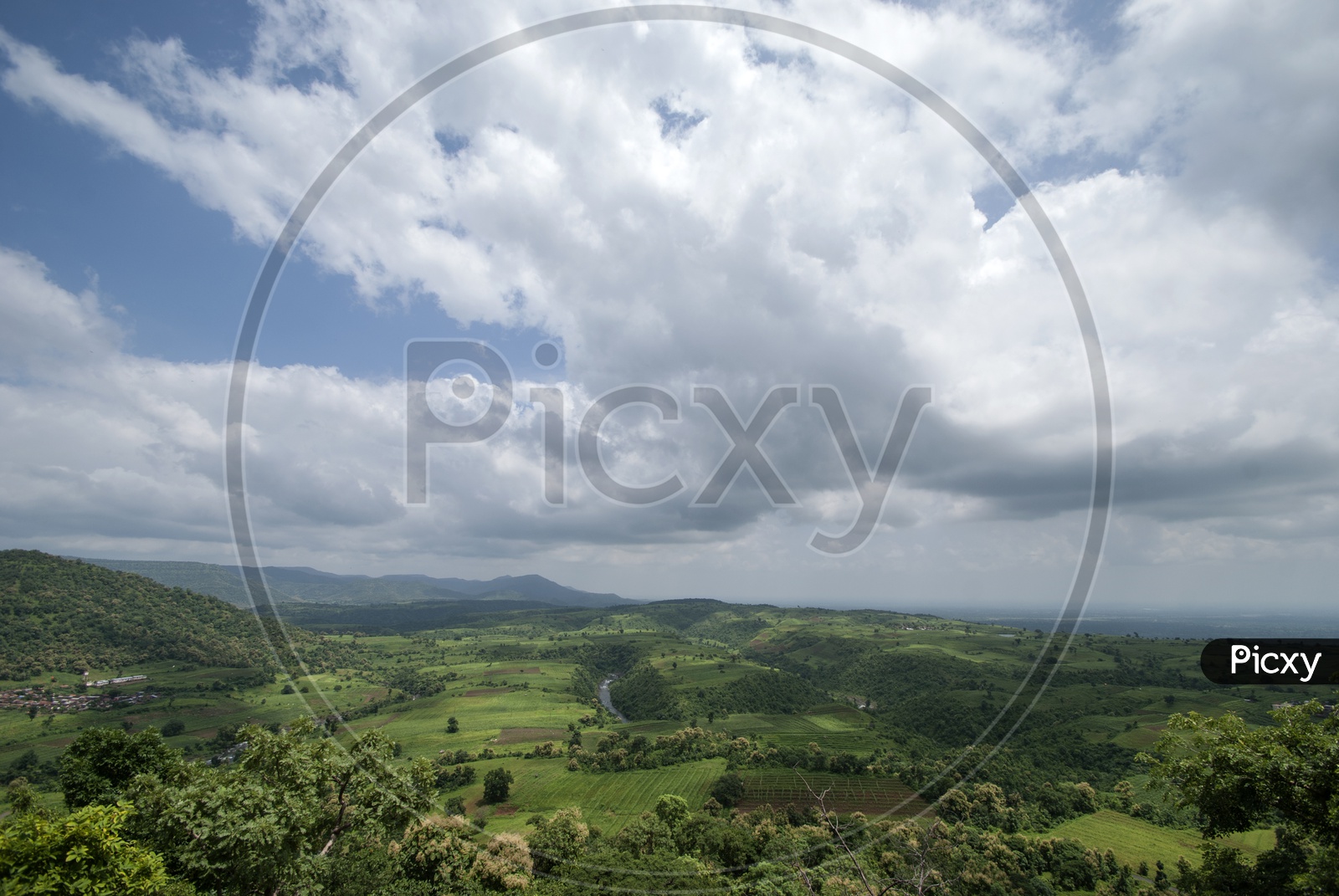 A Landscape With Aerial View of Agricultural Fields , Hills And Blue Sky With Cotton Clouds