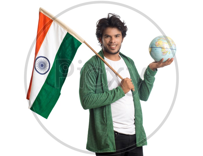 A Young Indian man Holding  Indian National Flag ( Tri Color )  And World Globe  In Hands And Posing Over a White Isolated Background