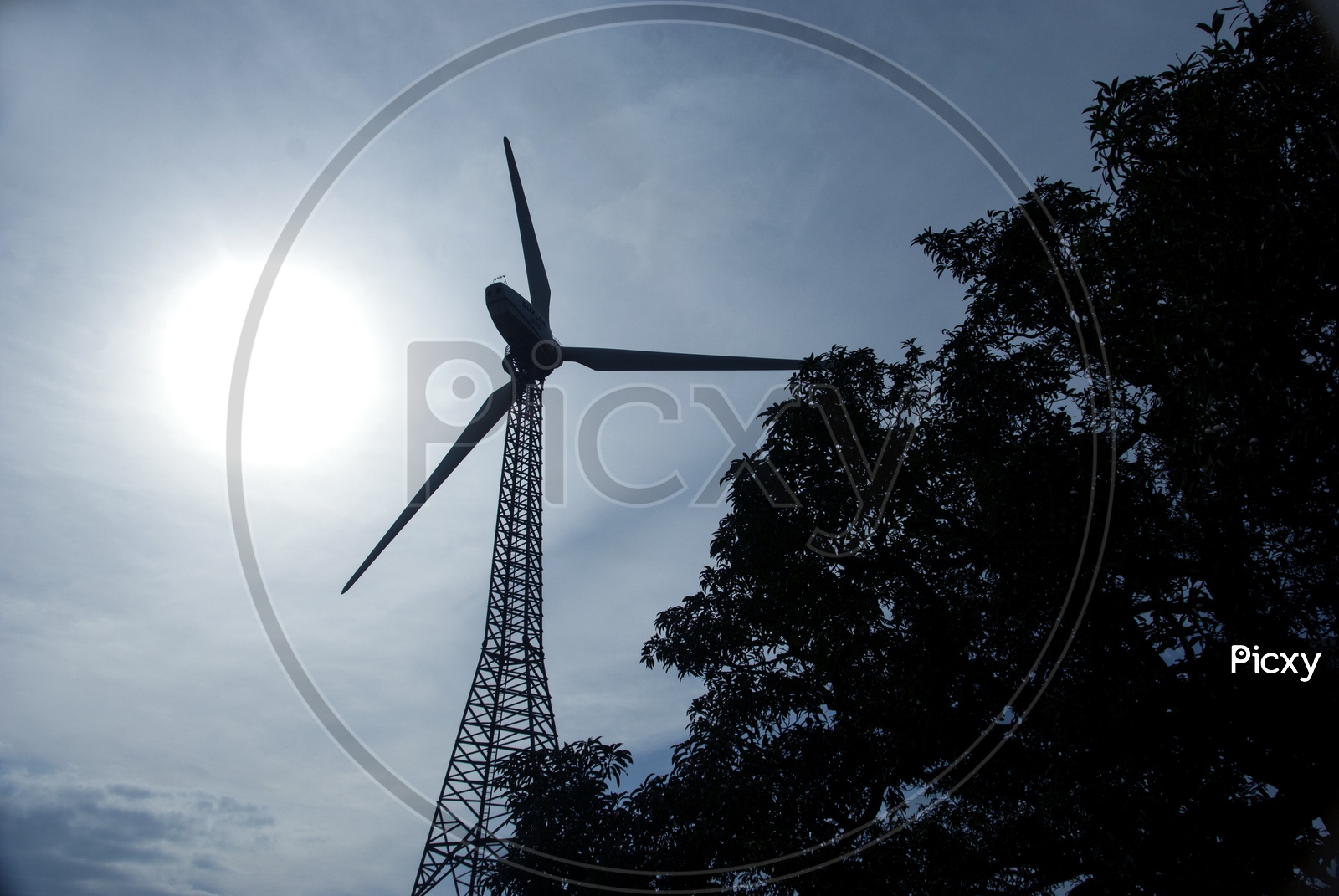 Wind Mills With Bright Sun In Background