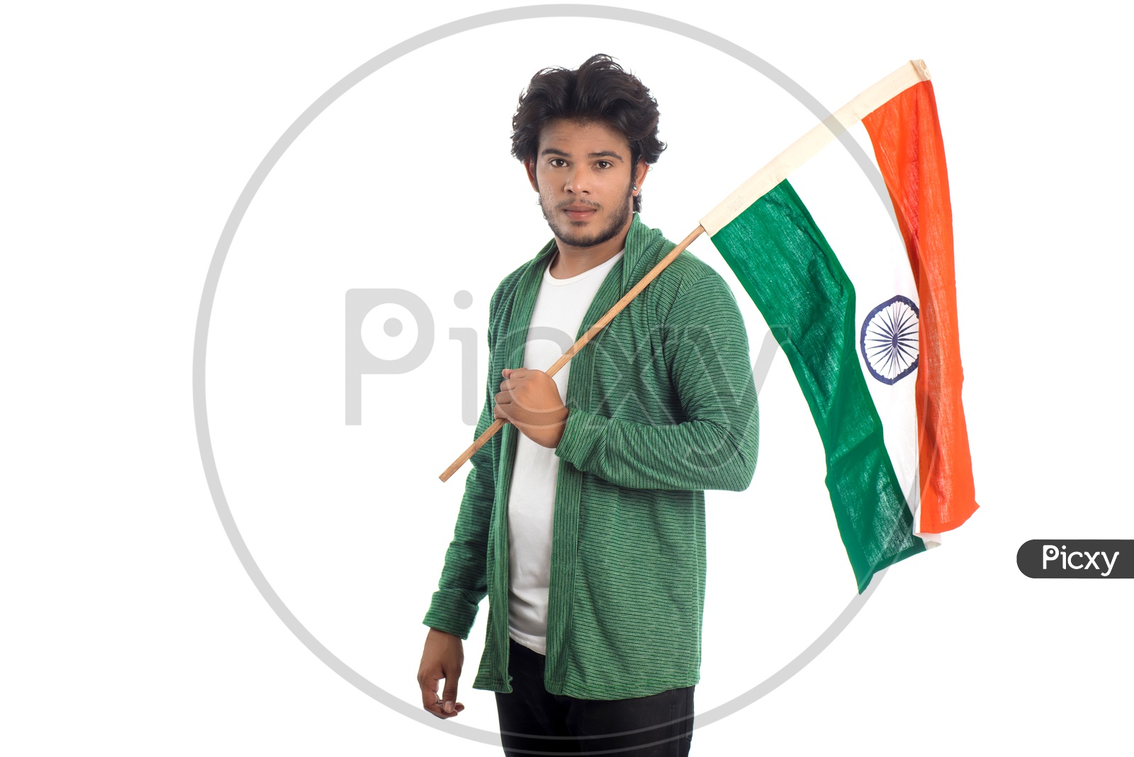 A Young Indian man Holding  Indian National Flag ( Tri Color )  In Hands And Posing Over a White Isolated Background