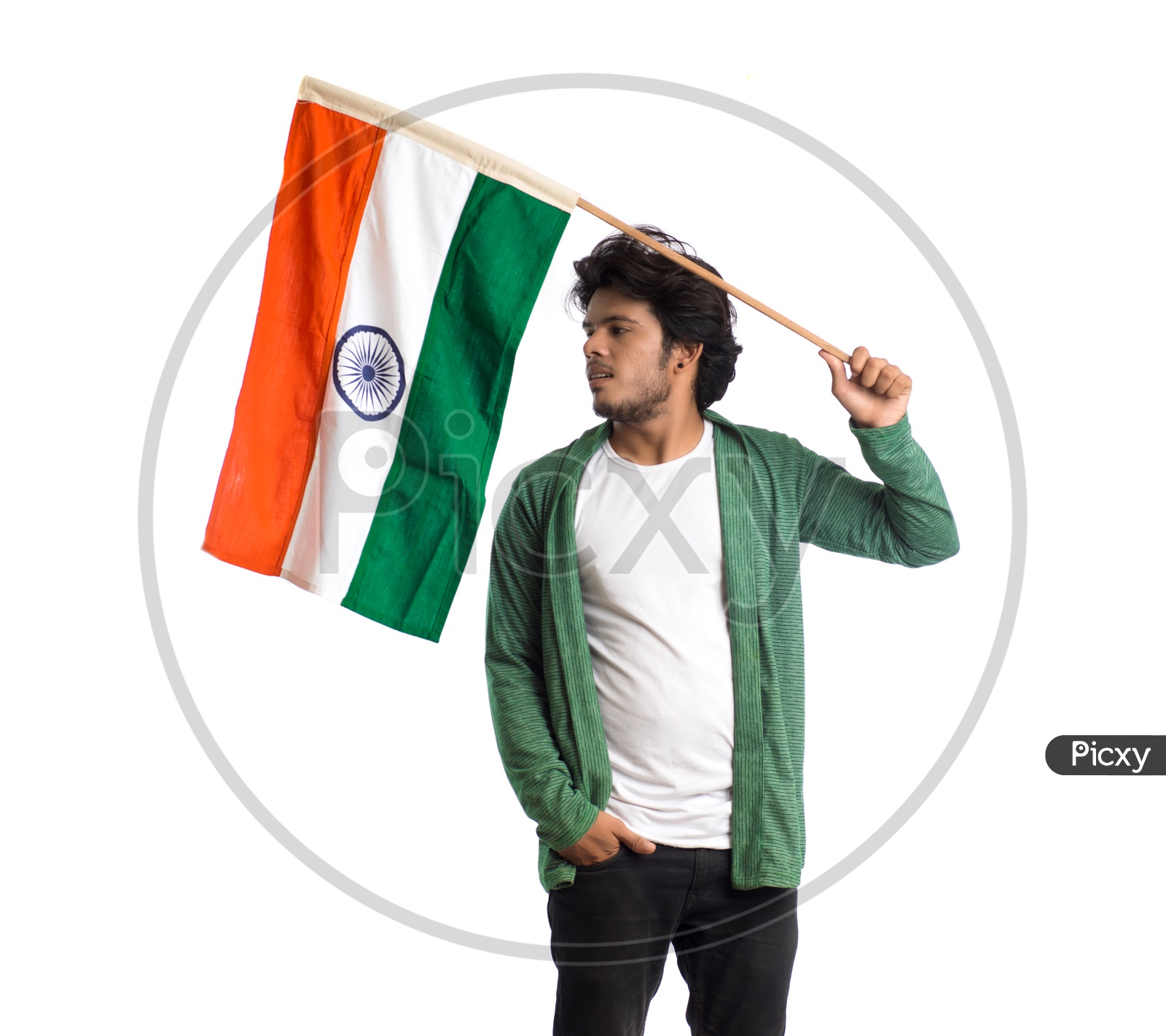 A Young Indian man Waving   Indian National Flag ( Tri Color )  In Hands And Posing Over a White Isolated Background