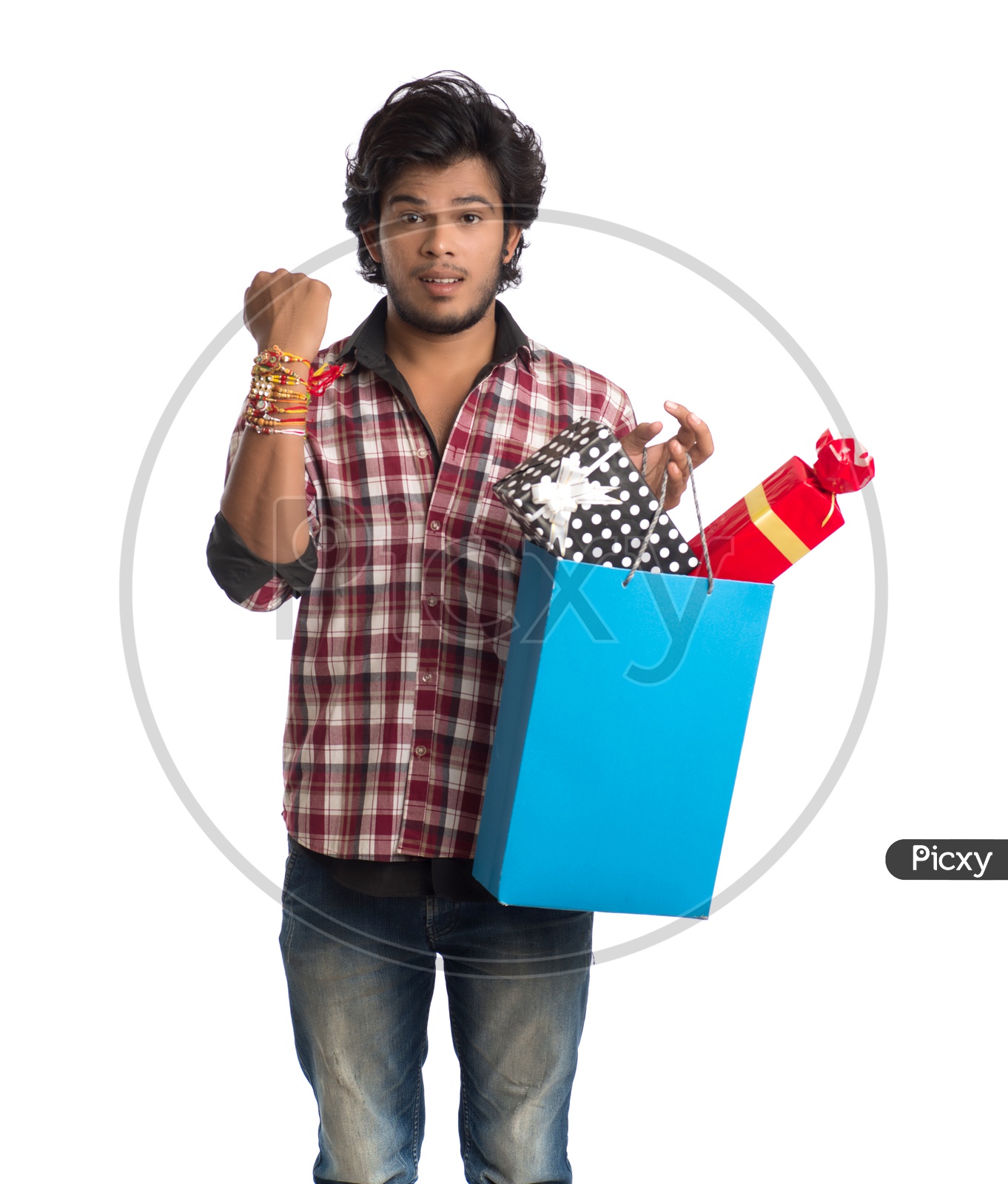 Indian Young Man Showing Rakhi Tied Hand And  with  a Gift Box For his Sister  On an  Isolated White Background