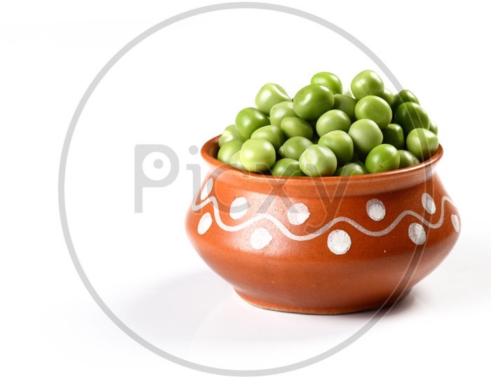 Fresh Green Peas in clay pot on An Isolated white background
