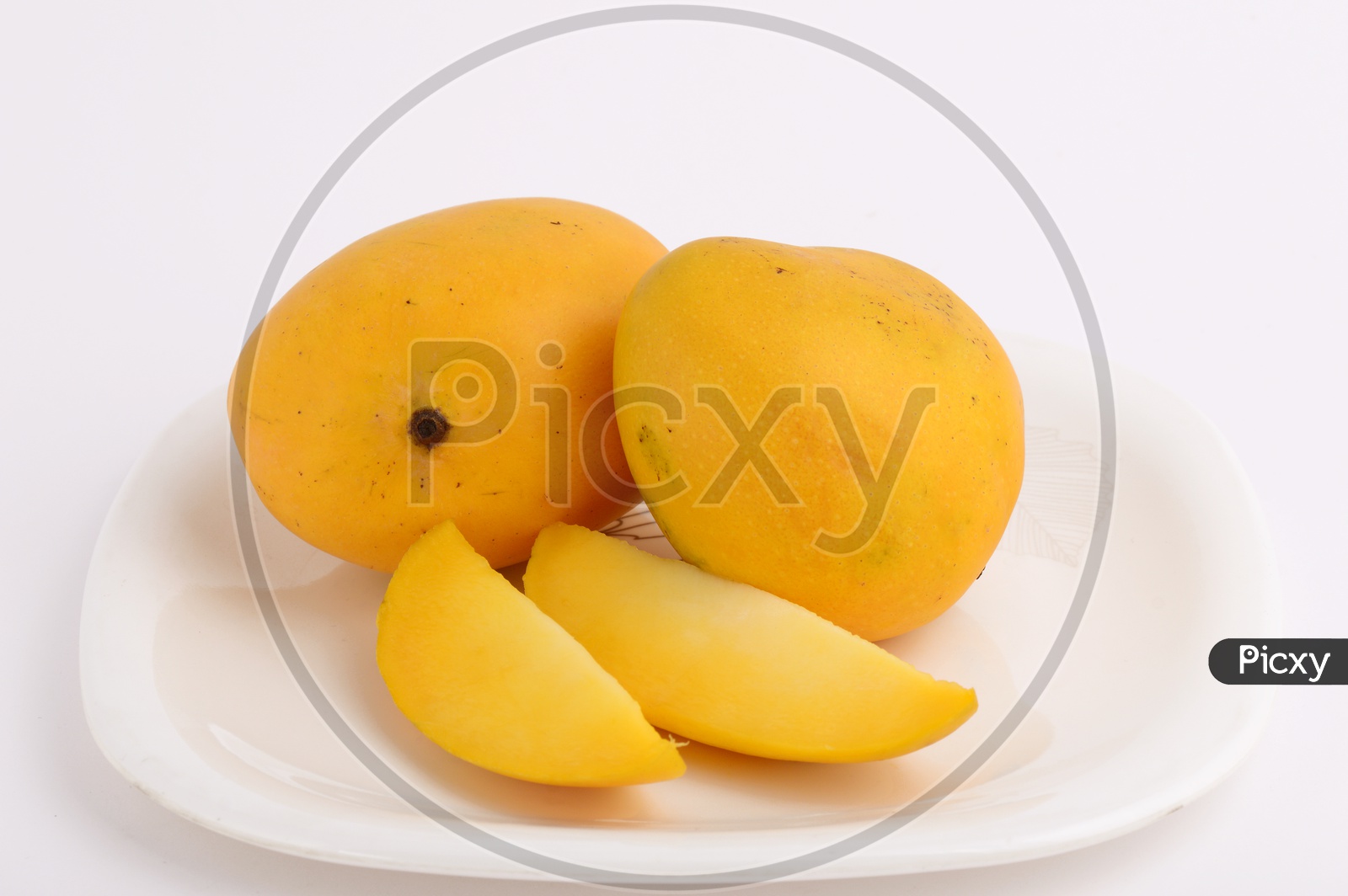 Image of Fresh Ripen Mangoes And Mango Slices On A White Plate On an ...