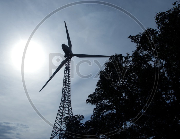Wind Mills With Bright Sun In Background