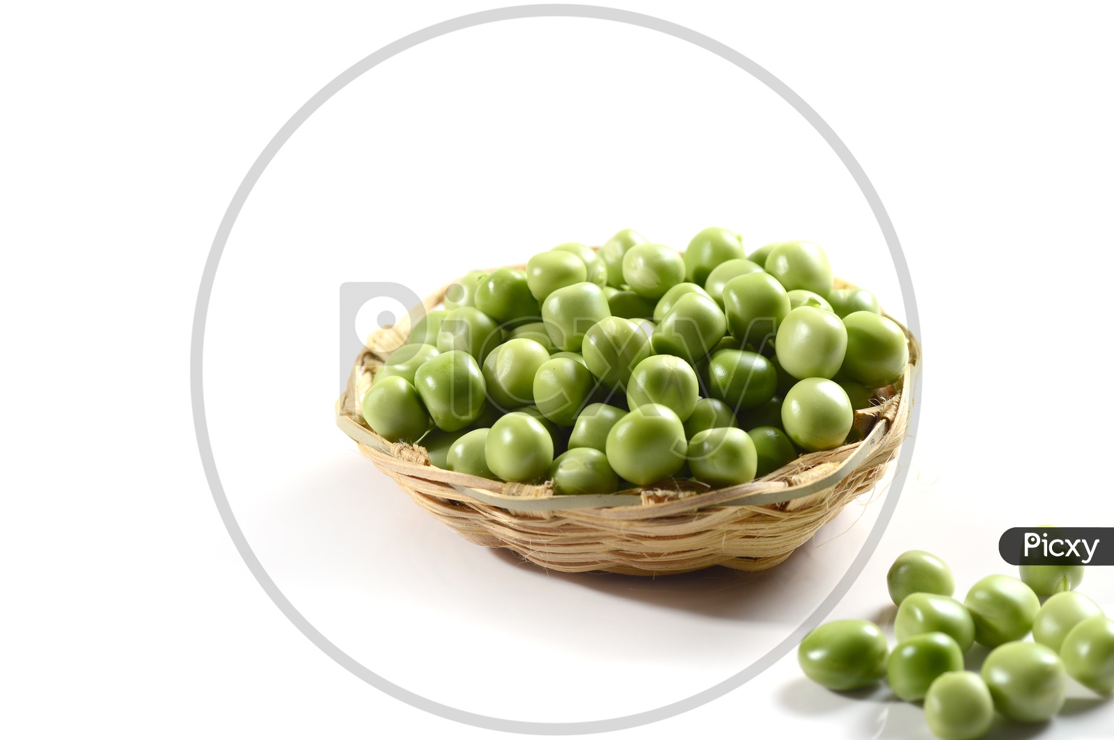 Fresh Green Peas in a Wooden Weaved basket on an Isolated  white background