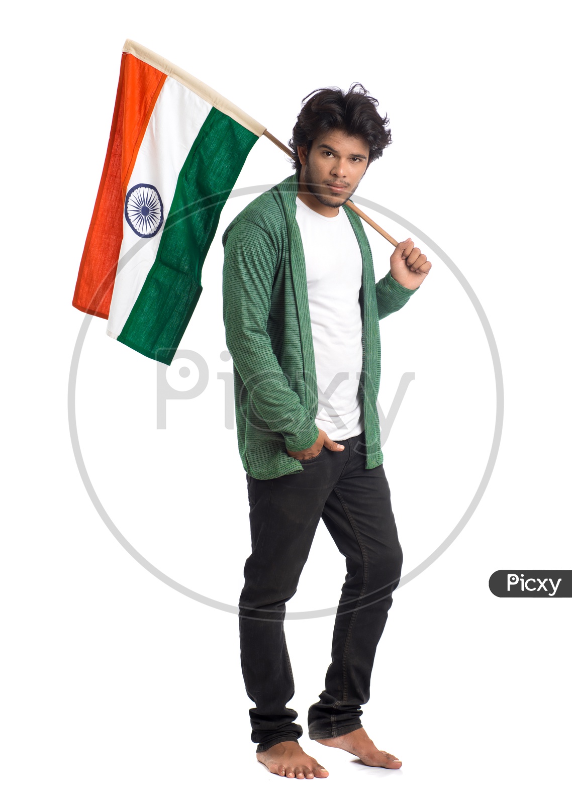 A Young Indian man Holding  Indian National Flag ( Tri Color )  In Hands And  Posing   Over a White Isolated Background