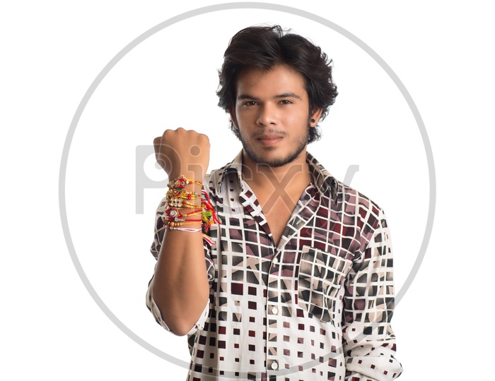 Indian Young Man Showing Rakhi Tied Hand And Smiling On an  Isolated White Background