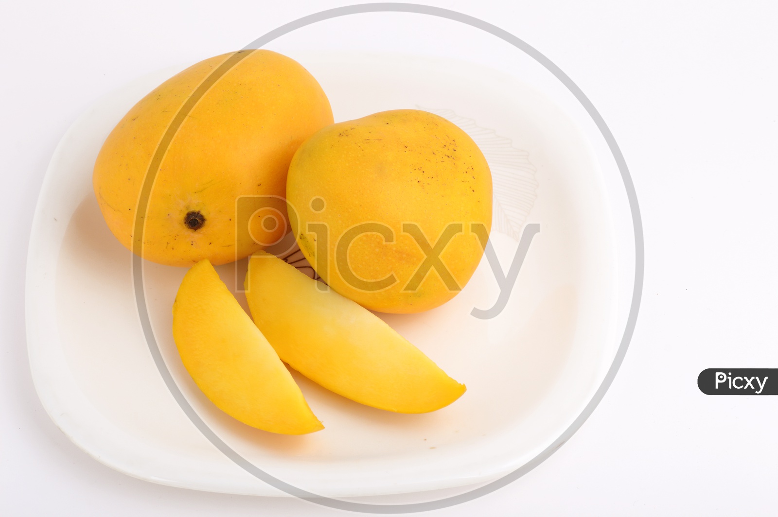 Fresh Ripen Mangoes And Mango Slices On A White Plate On an Isolated White Background