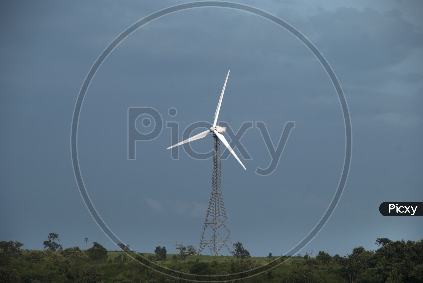 Wind Mill On a Green Terrain High Land With Blue Sky In  Background