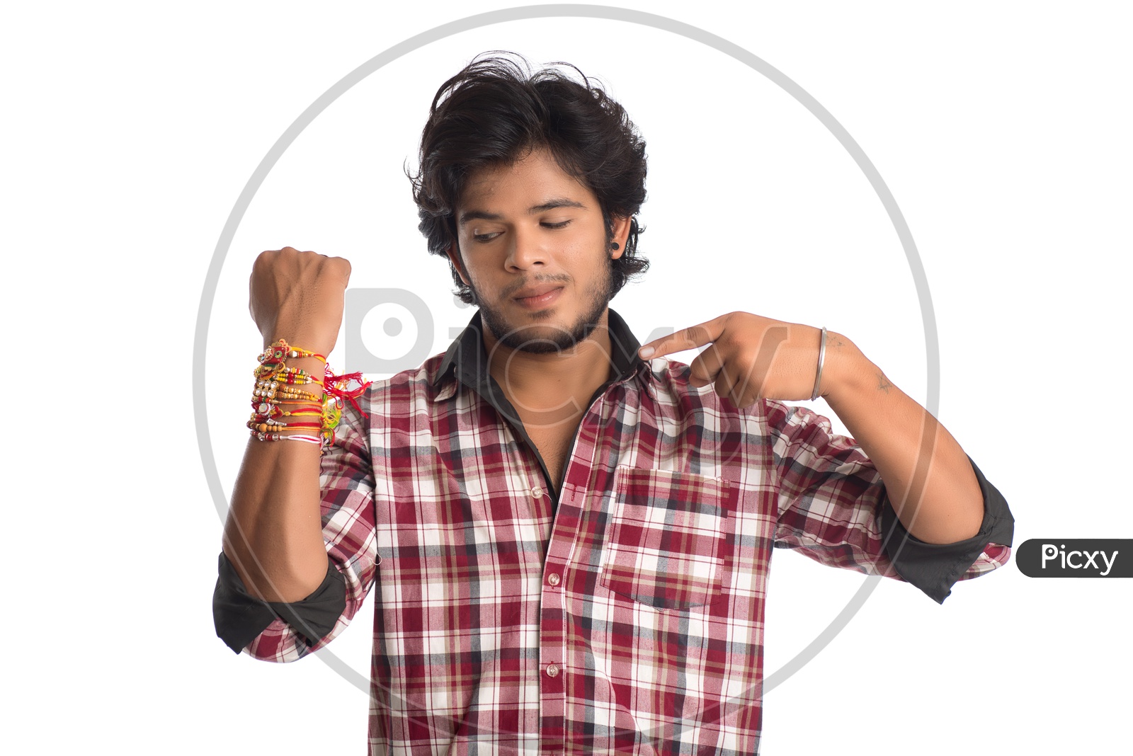 A Young Indian Man With a Elegant Rakhis Tied To His Hand And Posing Over a White Background