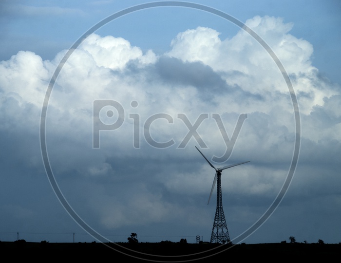 Wind mills , With a Blue Sky and Cotton Clouds In Background