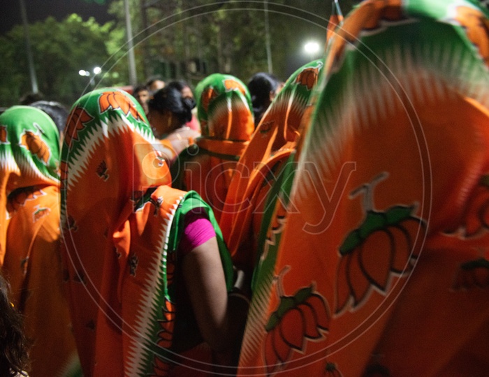 BJP Party Woman Supporters Or Party Workers Wearing The BJP Sarees Or Saris During The Election Campaign Rallies