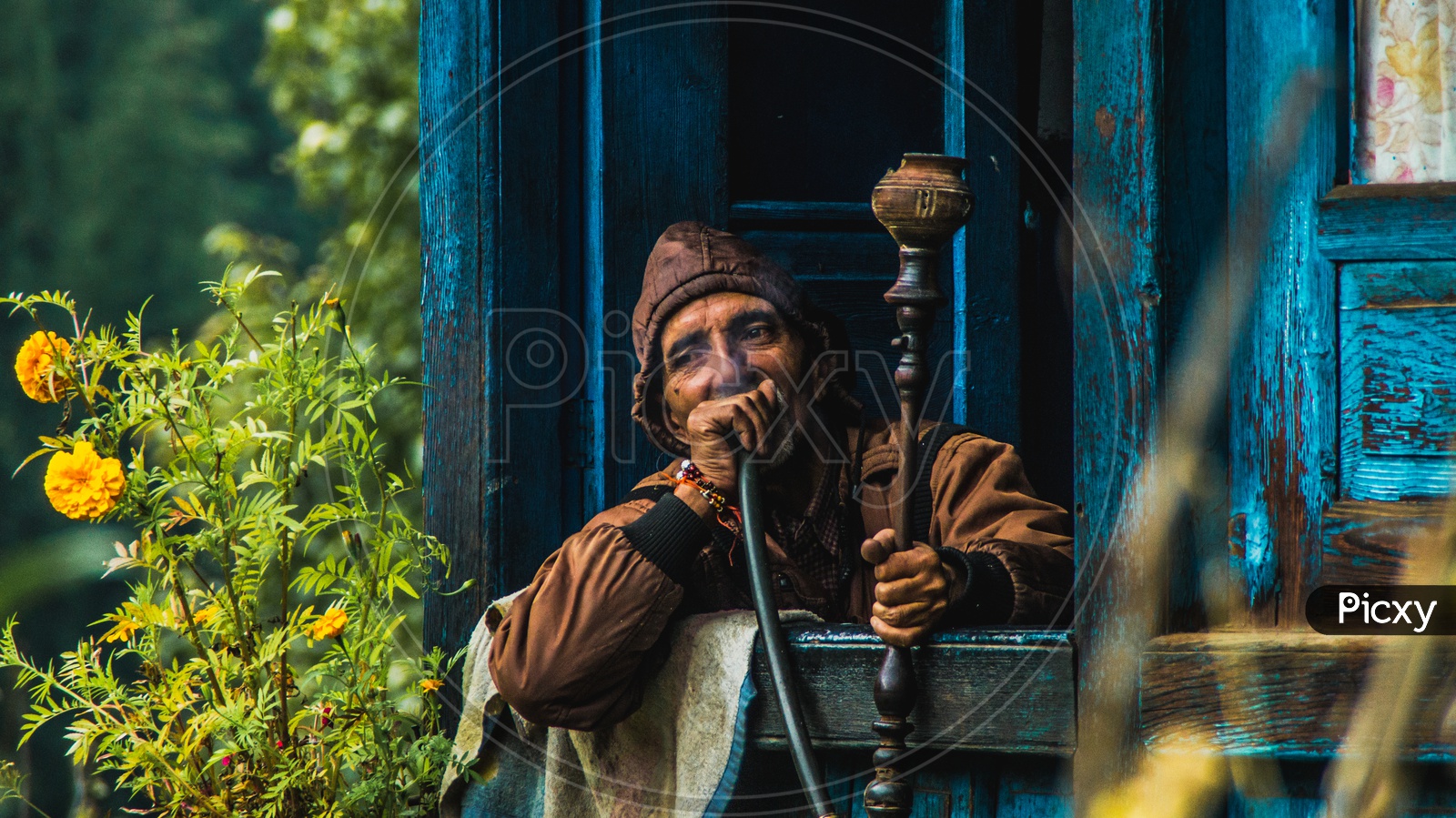 man enjoying hookah in his home