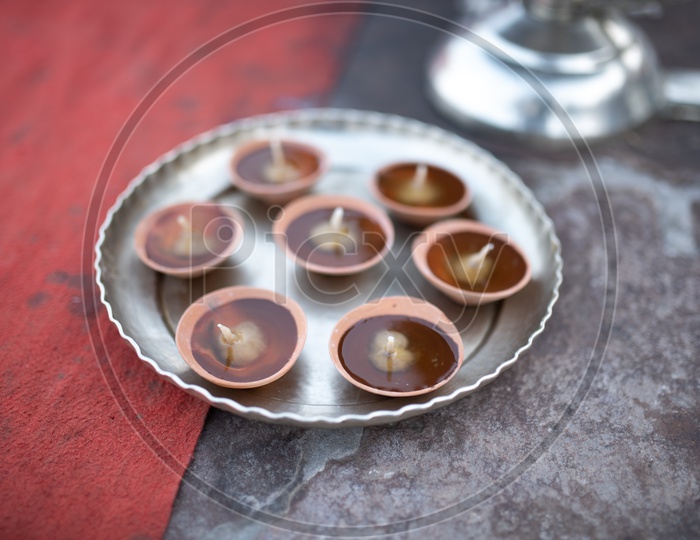 Dias On Clay Cups Filled With Oil and Cotton Bud Dipped  In Oil  In a Plate