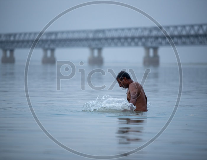 A Man Taking Bath In The Ganga River