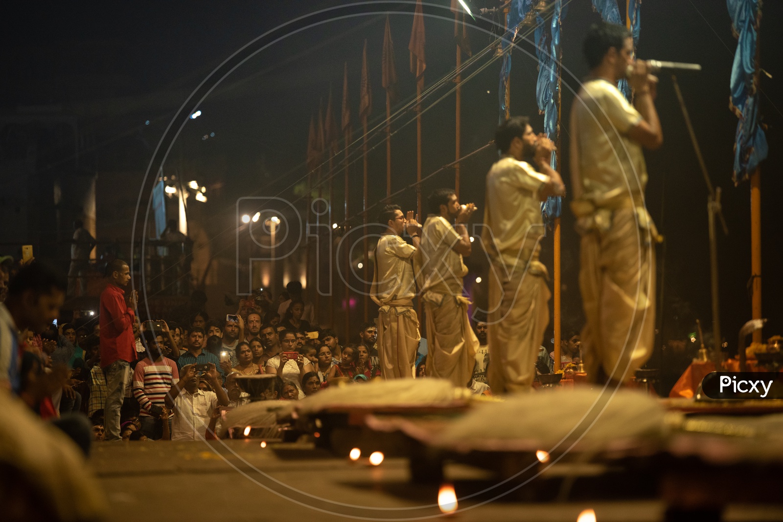 Indian Priests Performing The Ganga Aarti For The Sacred River Ganga  In Varanasi