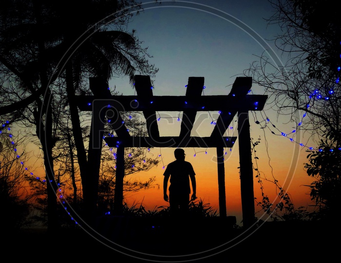 Silhouette Of a Man Standing Over a Sunset Sky In Background