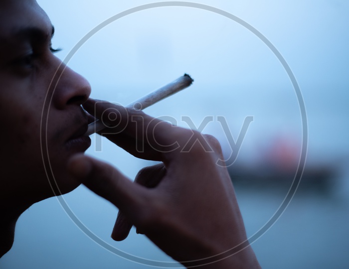 A Man Smoking Joint Or Ganja  Or Marijuna Or Weed  Cigar  Closeup