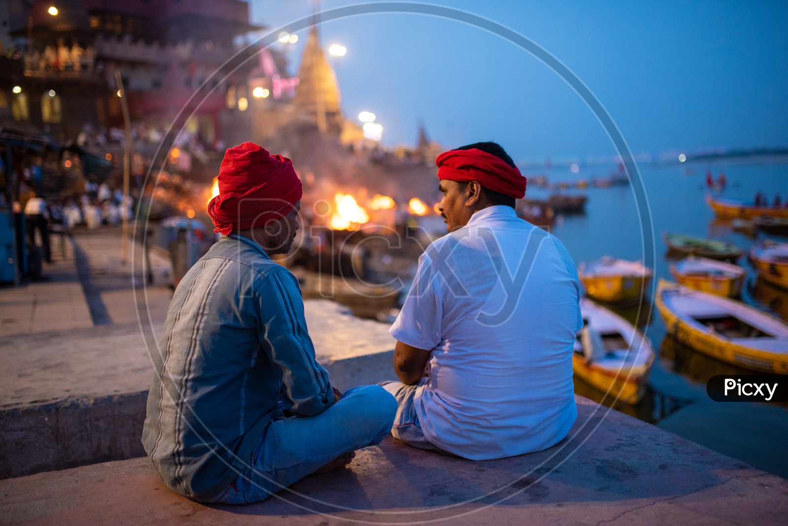 Local Man Sitting And Chit Chatting With Each Other at Manikarnika Ghat  In Varanasi