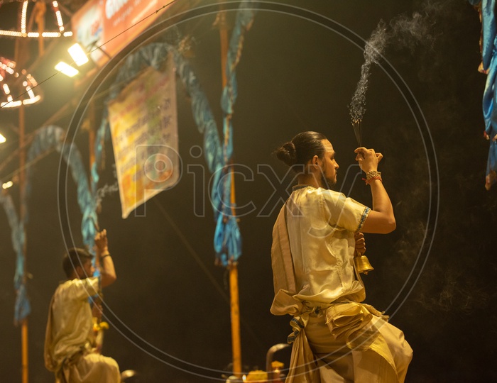 Indian Priests Performing The Ganga Aarti For The Sacred River Ganga  In Varanasi