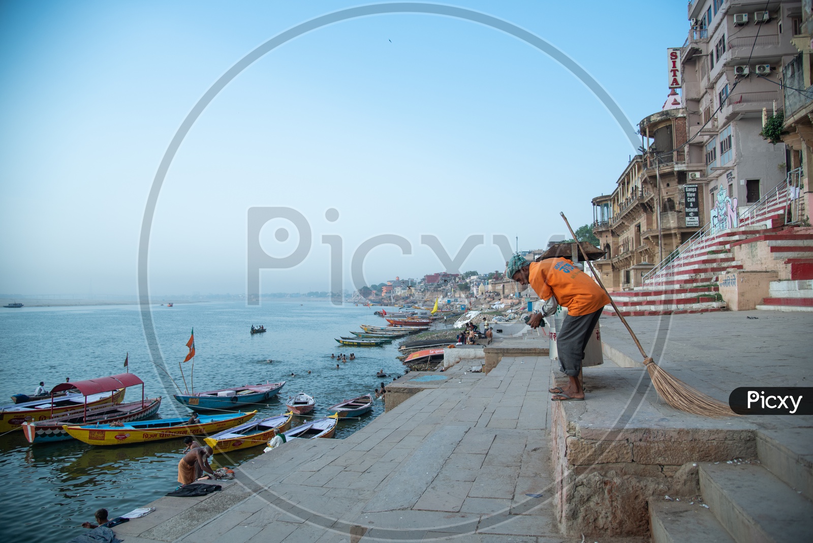 A  Municipal Corporation Worker Throwing The Trash in Dustbins On Ghats Of Varanasi