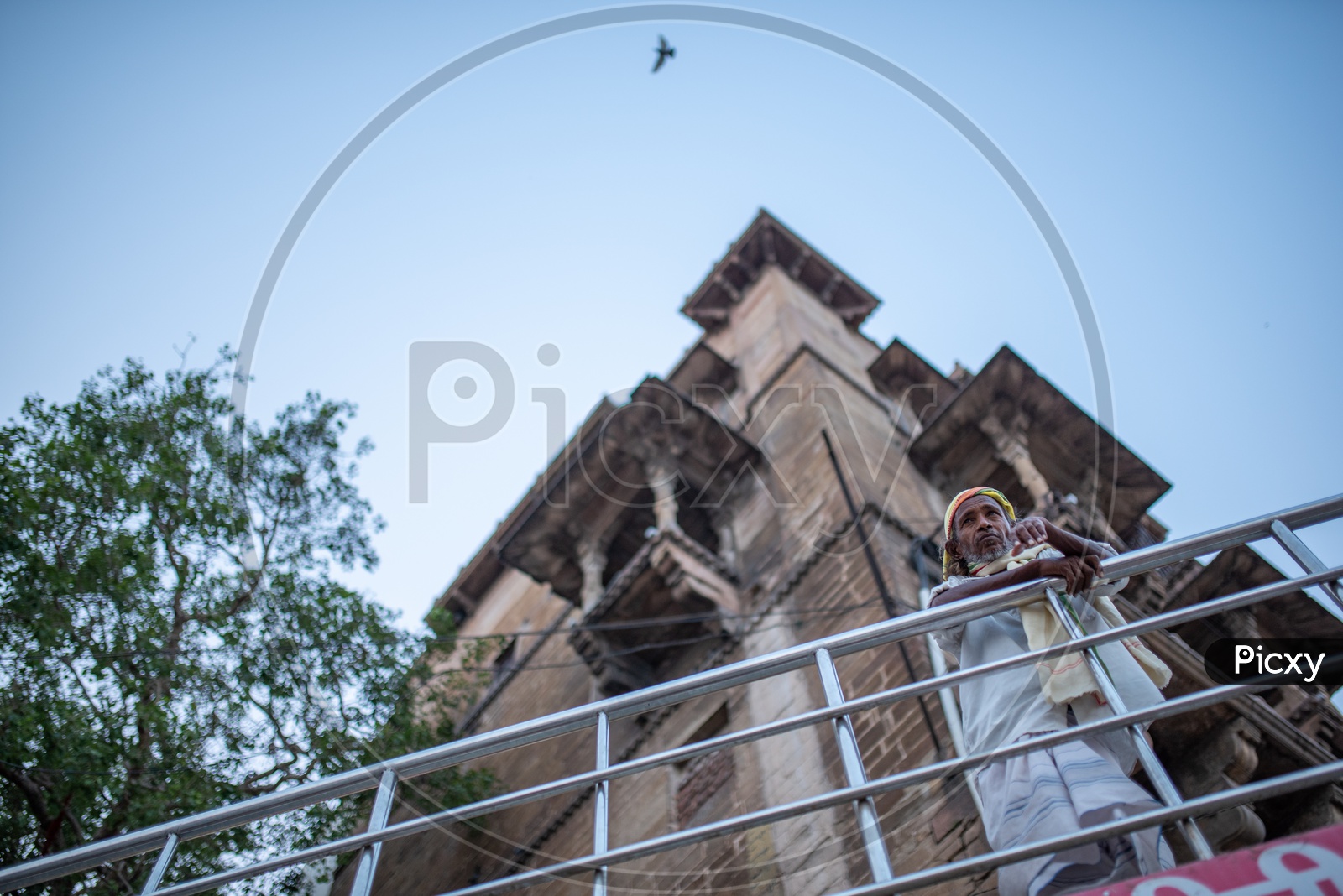 A Man Standing At a Ghat And Looking Into The Ganga River  Intensely  in Varanasi