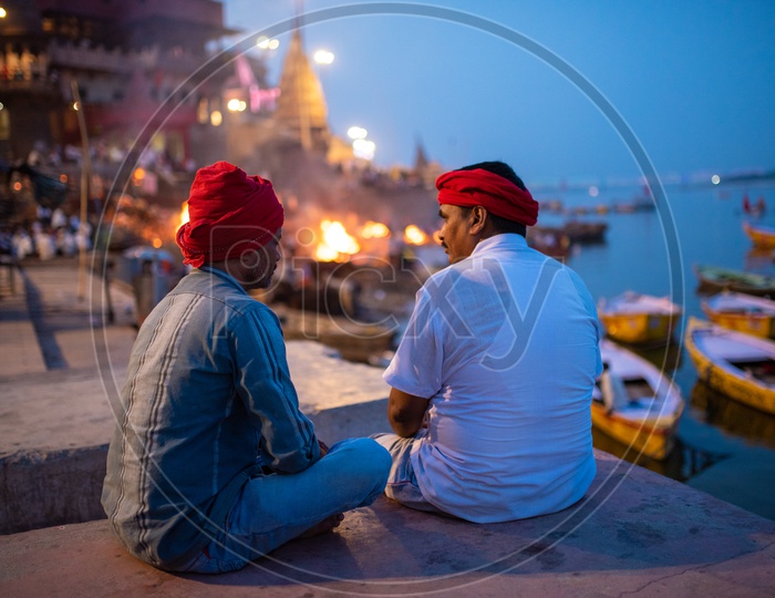 Local Man Sitting And Chit Chatting With Each Other at Manikarnika Ghat  In Varanasi