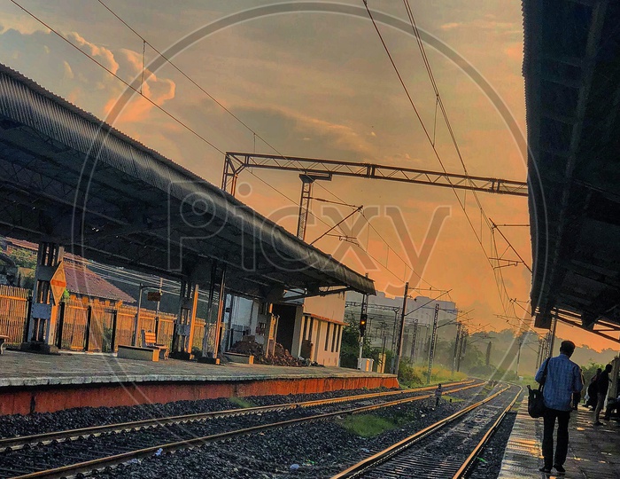 Railway Station With A  Passenger Walking With Sunset Sky As a Background
