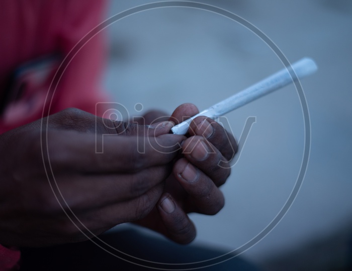 An Indian Making  The Cigar With Marijuna  Or Weed Or Ganja  Leafs  Closeup