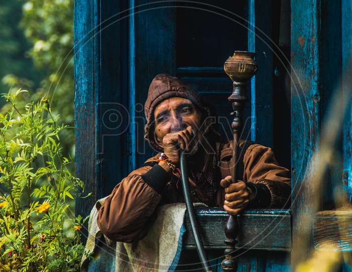 man enjoying hookah in his home